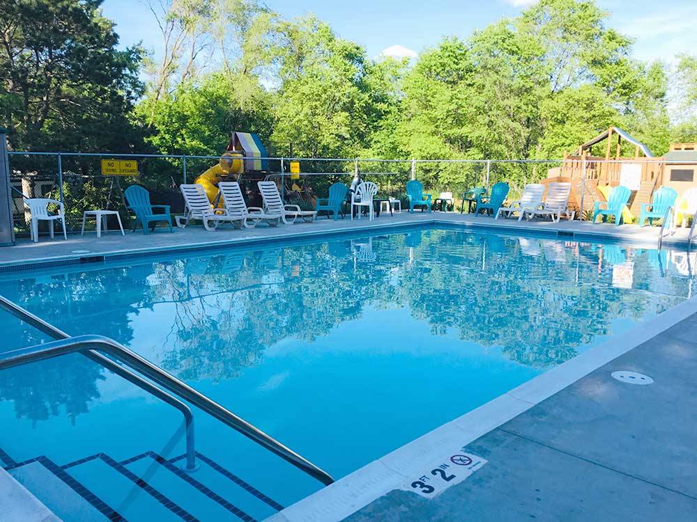 Swimming pool with chaise lounges at ST CLOUDCLEARWATER RV PARK
