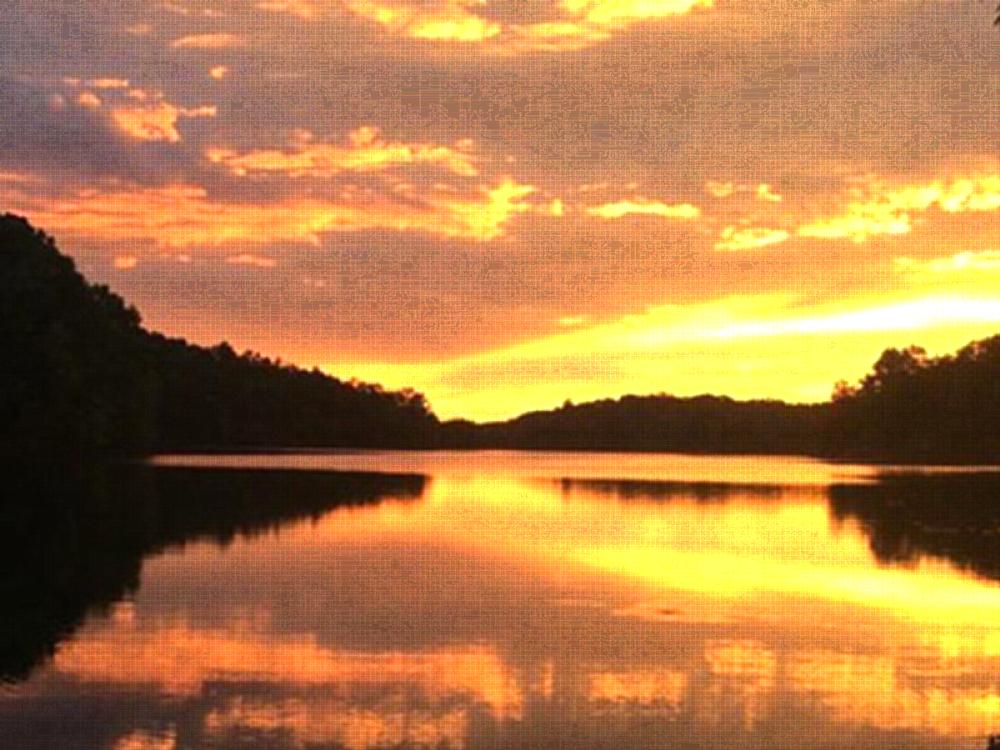 Sun setting over lake at Mountain Lake Campground
