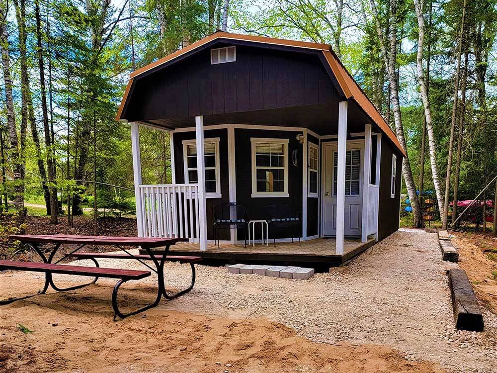 One of the cabin rentals with a fire pit at BIG CEDAR CAMPGROUND & CANOE LIVERY