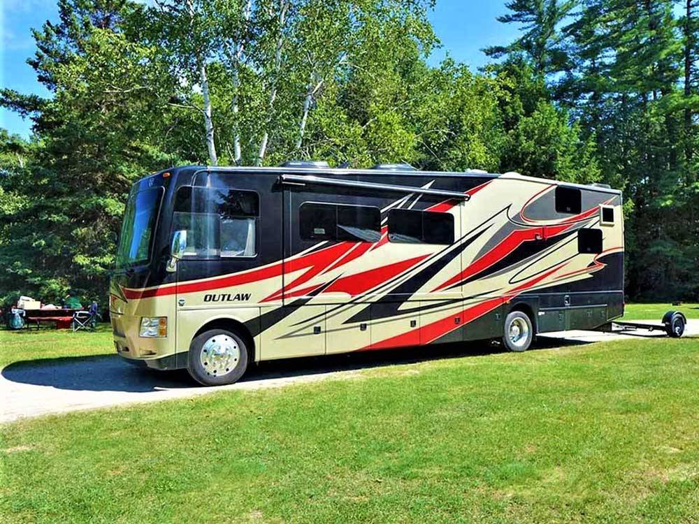 A large motorhome in a RV site at BIG CEDAR CAMPGROUND & CANOE LIVERY