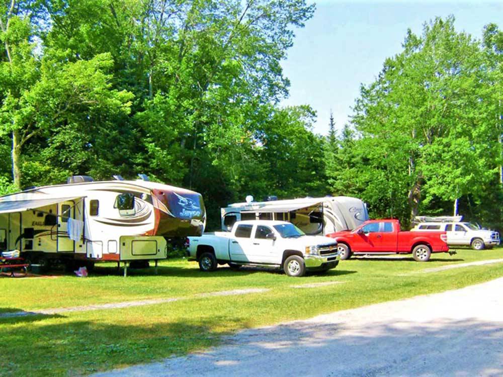 Trailers backed in at the grassy sites at BIG CEDAR CAMPGROUND & CANOE LIVERY
