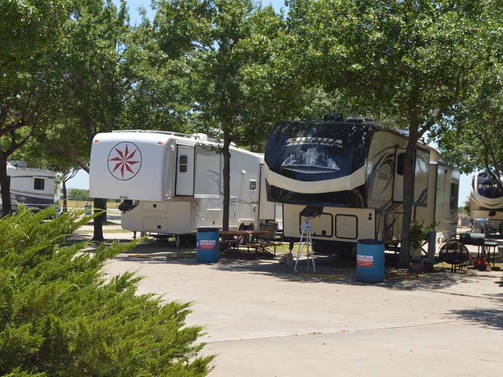 Two fifth wheels parked in sites at TRADERS VILLAGE RV PARK