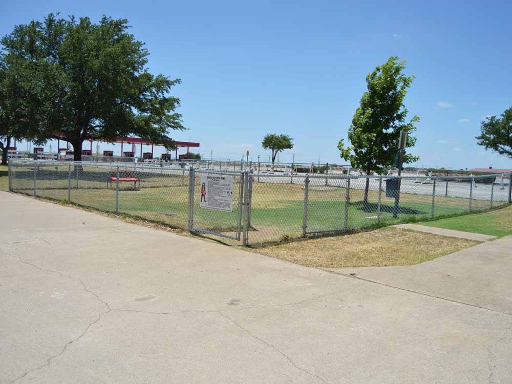 The fenced in dog area at TRADERS VILLAGE RV PARK