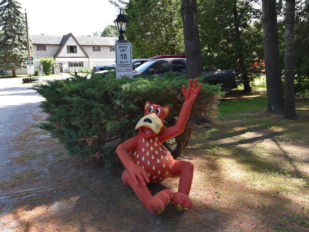 A mascot figurine next to a bush at COBOURG EAST CAMPGROUND