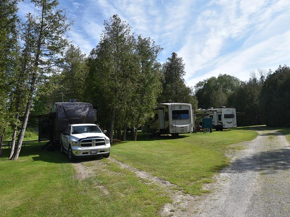 A row of trailers parked in sites at COBOURG EAST CAMPGROUND