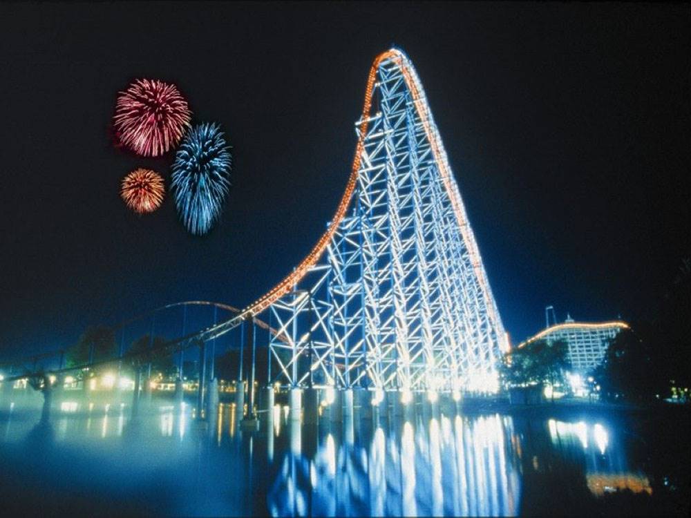 The amusement park at night with fireworks
