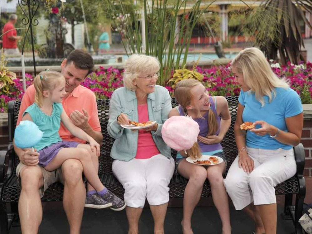 Multi generations enjoying pizza and cotton candy
