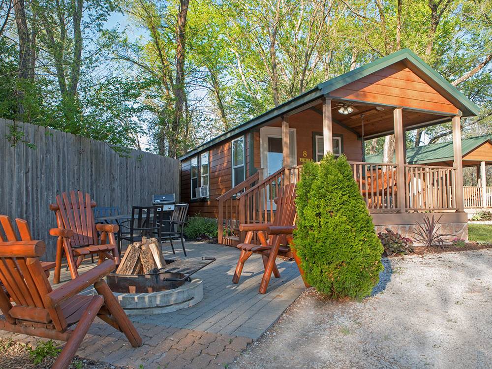 A fire pit with chairs near a rental