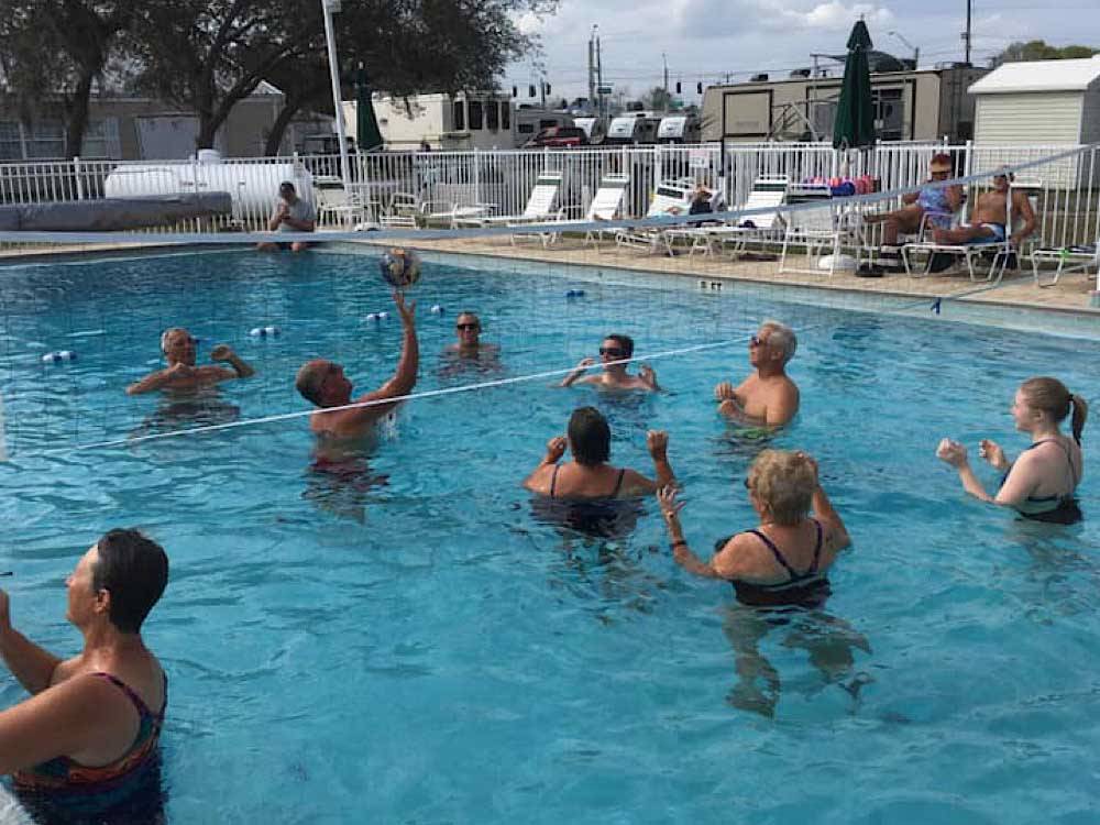 Campers playing volleyball in the pool at CYPRESS CAMPGROUND & RV PARK