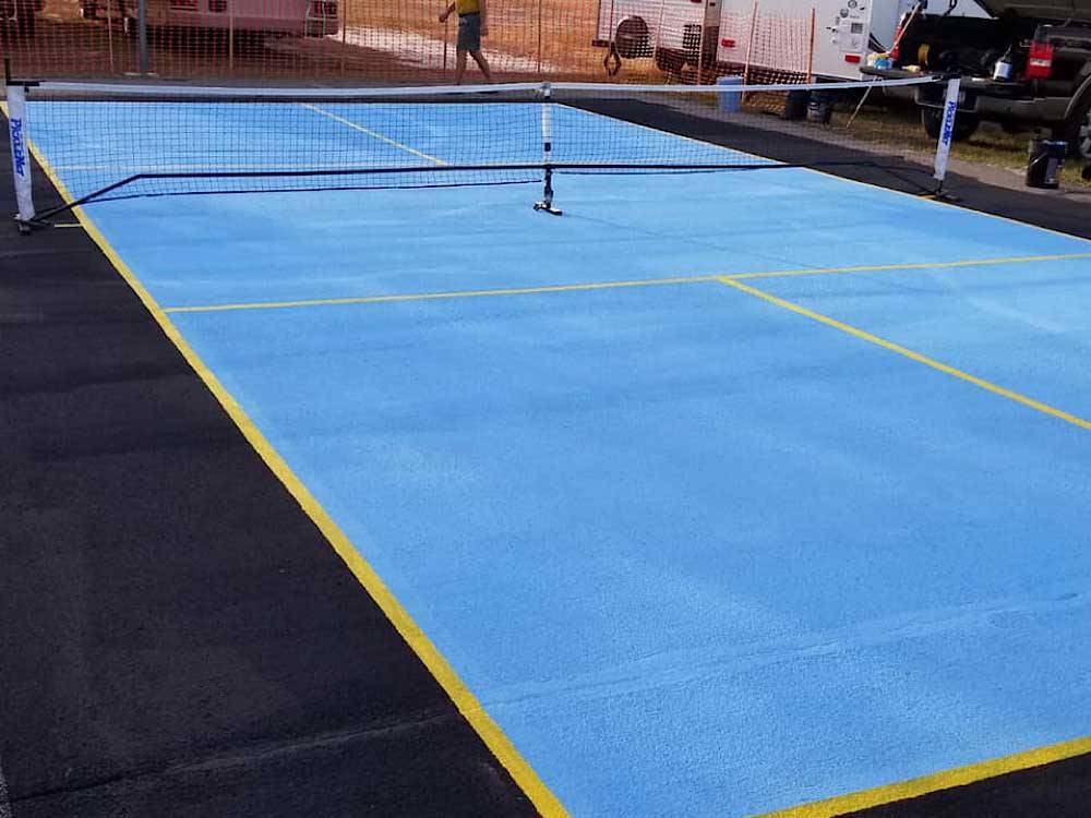 The blue pickleball court at CYPRESS CAMPGROUND & RV PARK