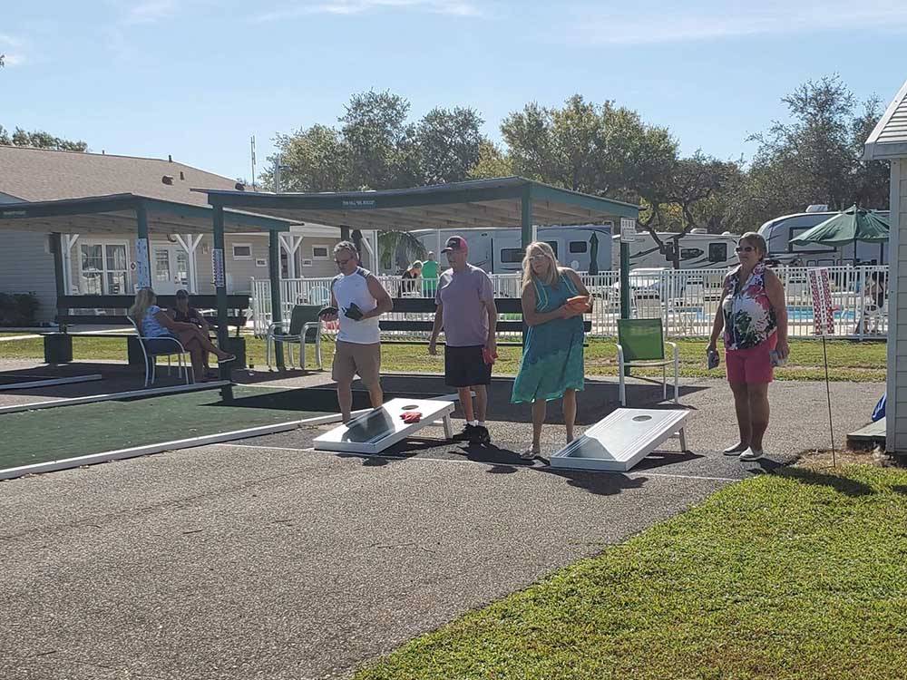 Couples playing corn hole at CYPRESS CAMPGROUND & RV PARK