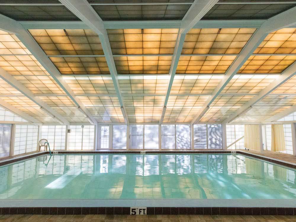 Indoor pool with translucent ceiling tiles at HOLIDAY RV VILLAGE