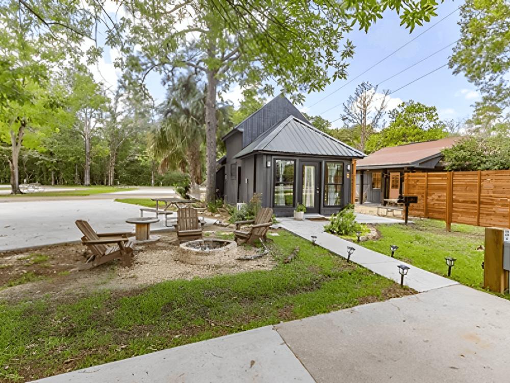 Cabin with fire pit in front at site Adventures RV Resort