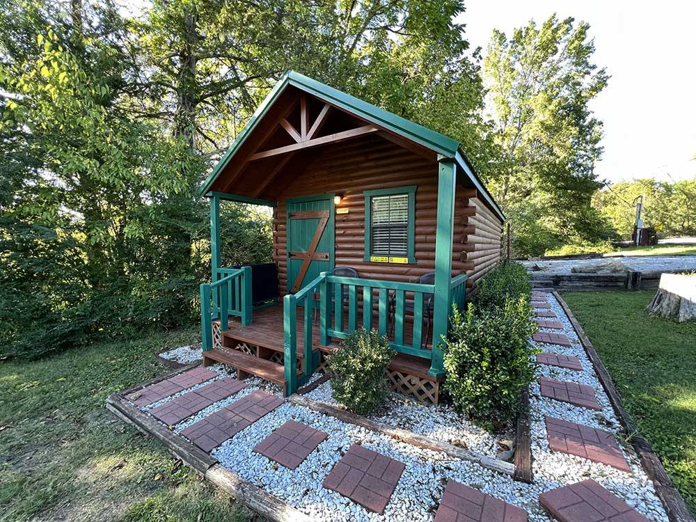 The brown and green wooden cabin rental at KNOXVILLE CAMPGROUND
