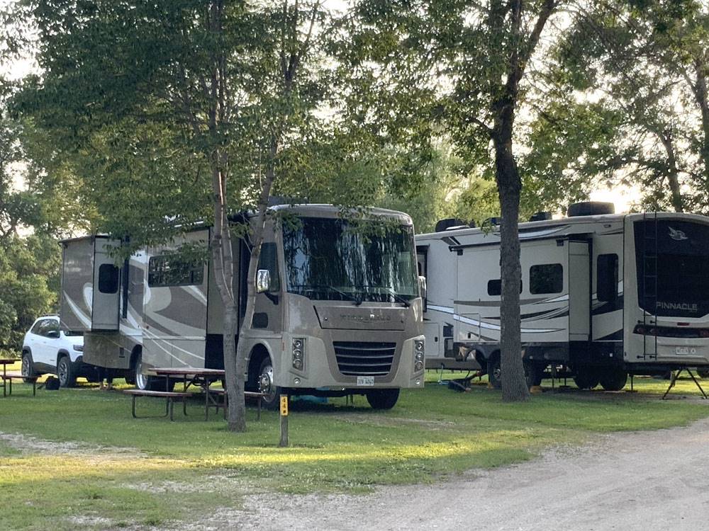 Class A RV with slide-outs and trailer in RV sites at Jamestown Campground