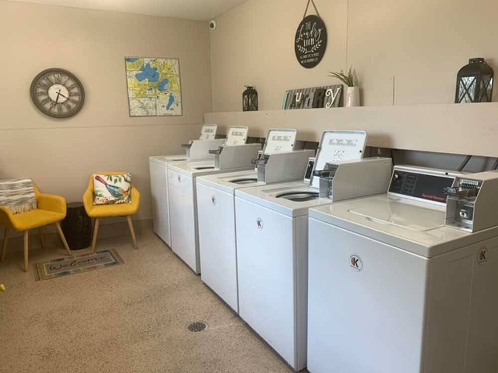 Washing machines and two chairs in the laundry room at MADISON CAMPGROUND