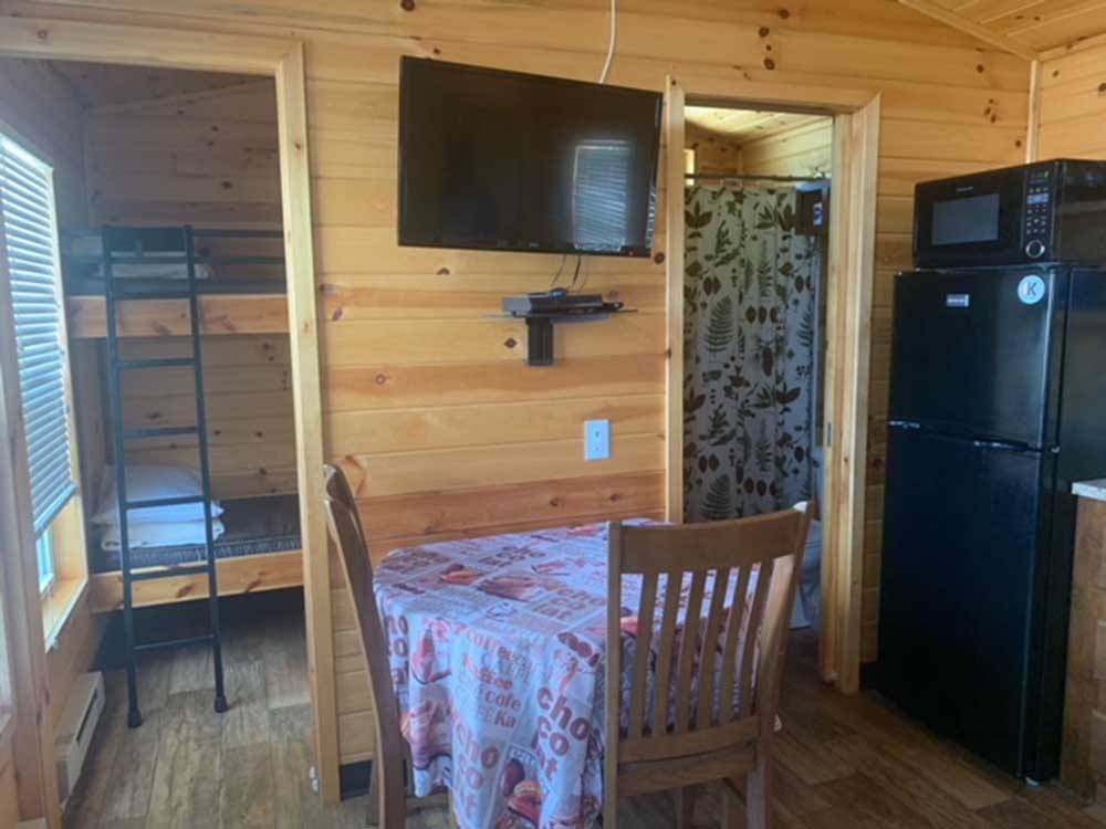 The kitchen area and bunk beds in the cabin at MADISON CAMPGROUND