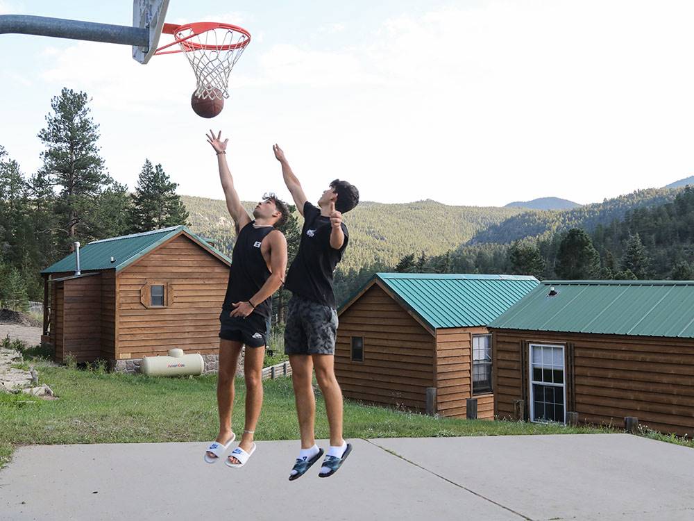 Two men playing basketball at JELLYSTONE PARK ESTES