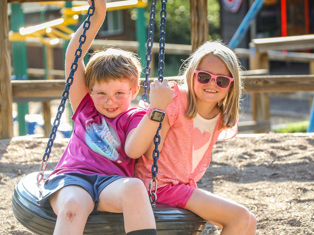 Kids on a tire swing at JELLYSTONE PARK ESTES