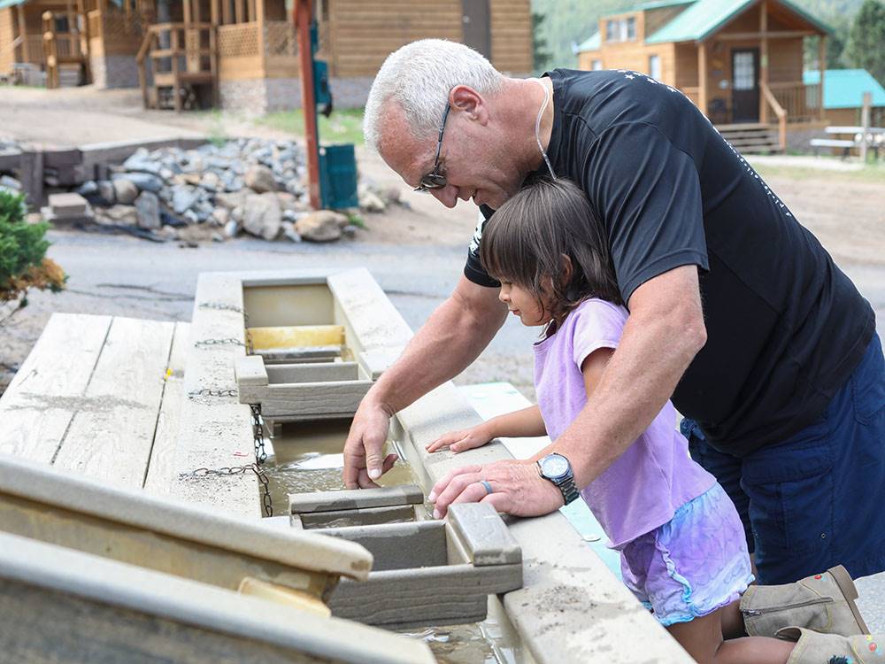 Playing with a sand table at JELLYSTONE PARK ESTES