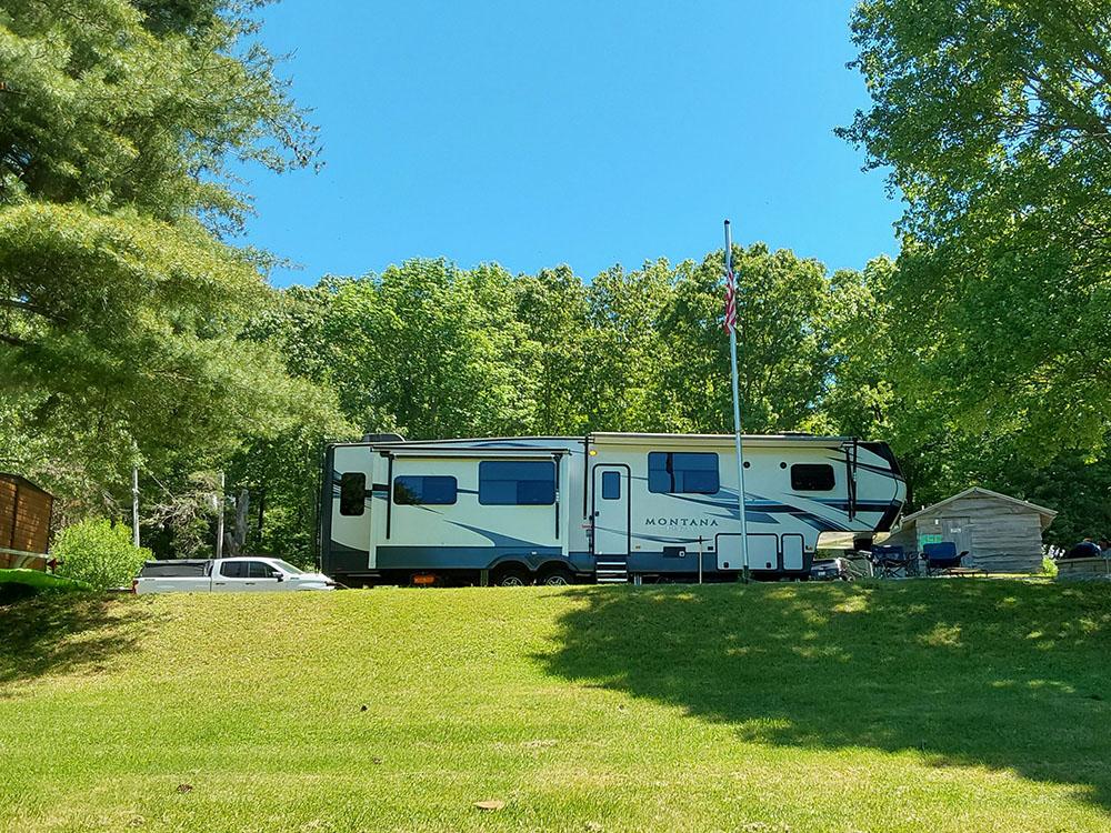 RV in a tree lined site at COLALUCA FAMILY CAMPGROUND