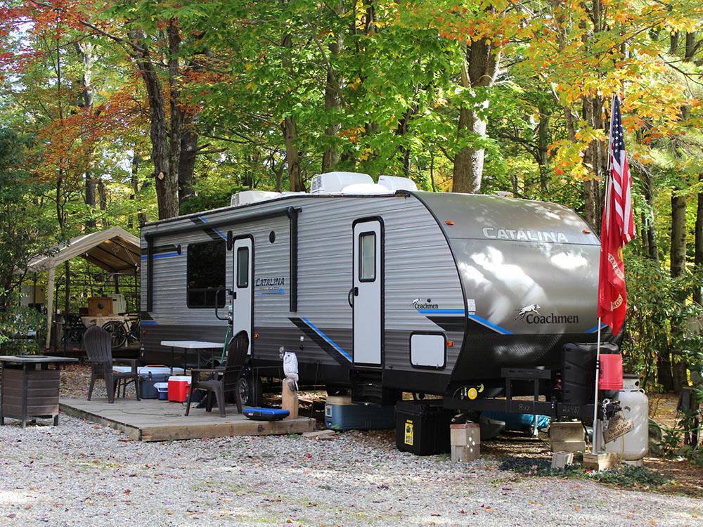 A travel trailer in a gravel site at PROSPECT MOUNTAIN CAMPGROUND