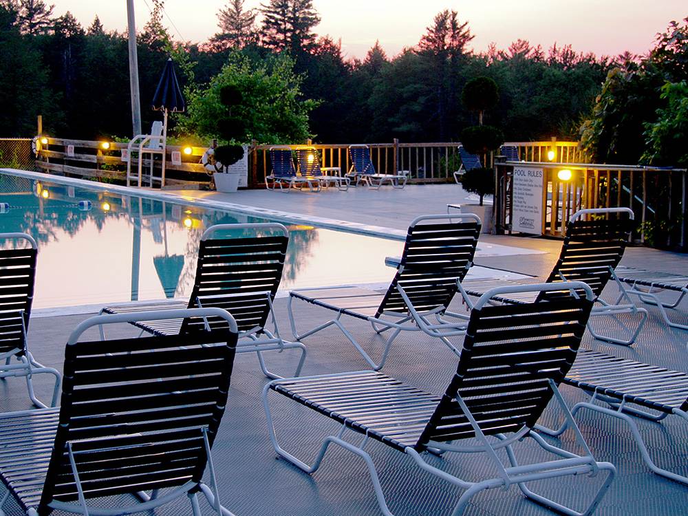 Pool-side lounge chairs at dusk