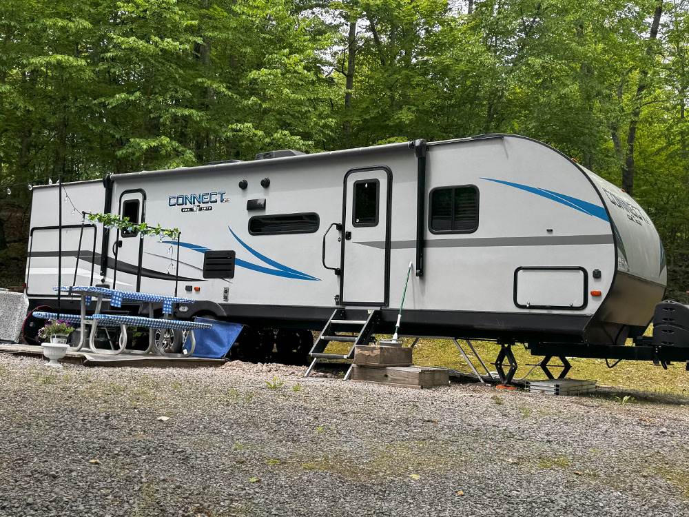 A large RV with picnic table at site