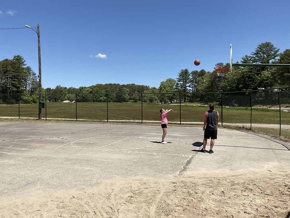 Two people playing basketball at CAPE COD'S MAPLE PARK CAMPGROUND & RV PARK