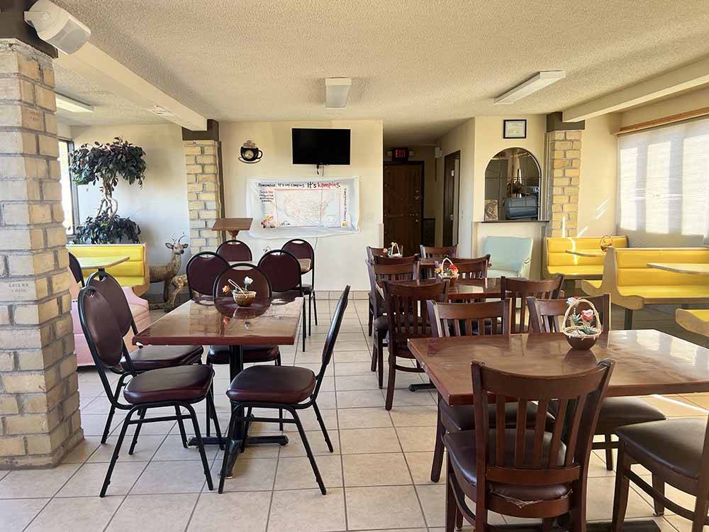 Chairs and tables inside a restaurant at LORDSBURG KOA JOURNEY