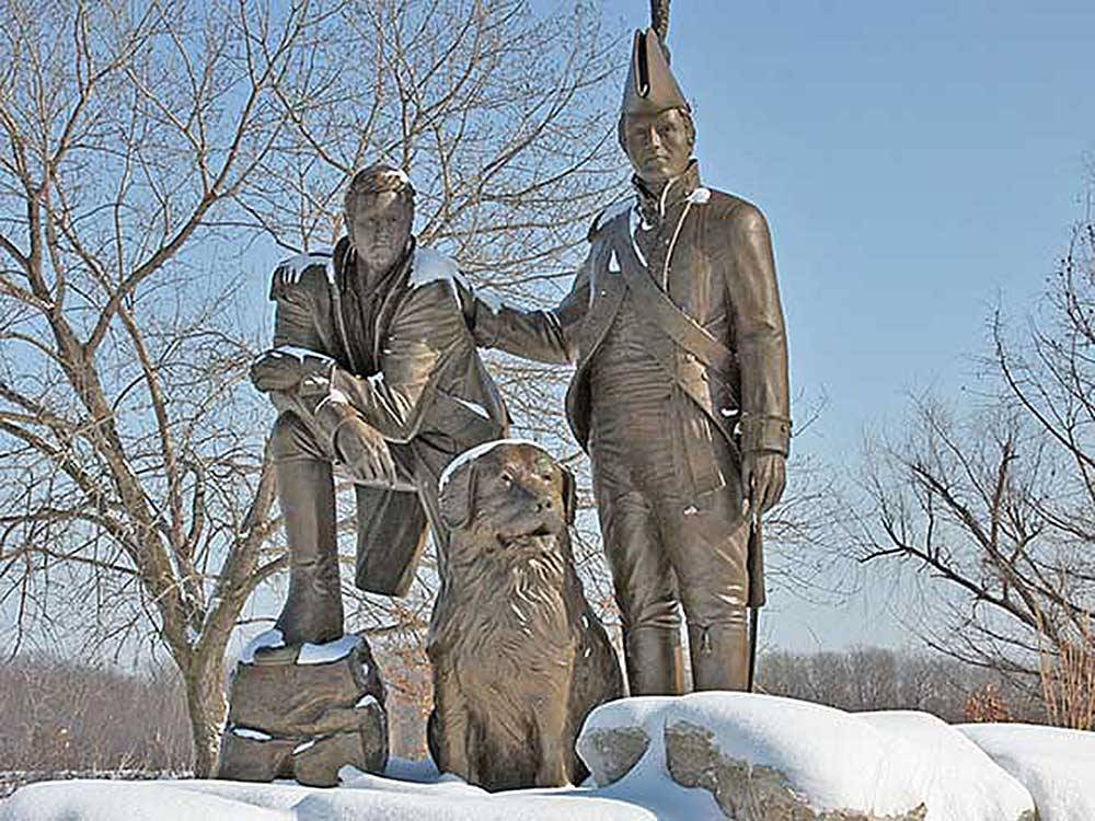 Statue of two soldiers and a dog at SUNDERMEIER RV PARK