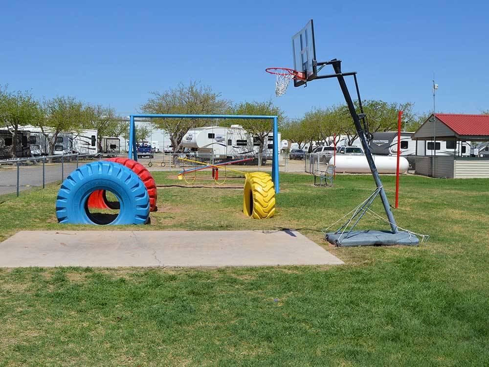 Playground area with basketball court at MIDLAND/ODESSA RV PARK