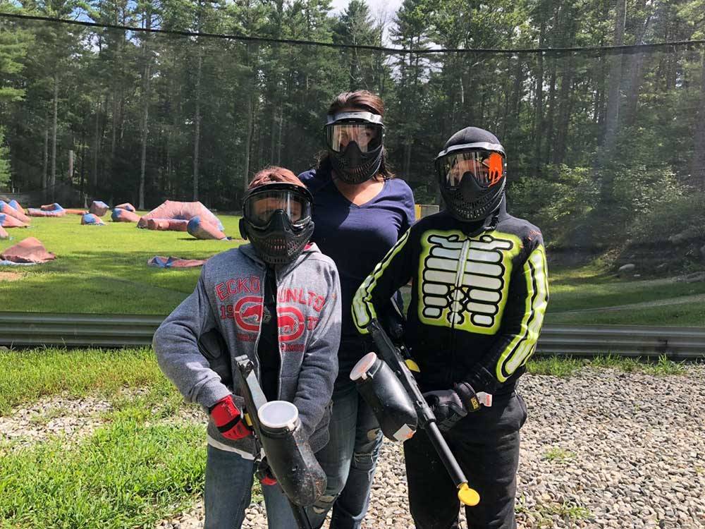 Three campers getting ready for paintball at NATURES CAMPSITES