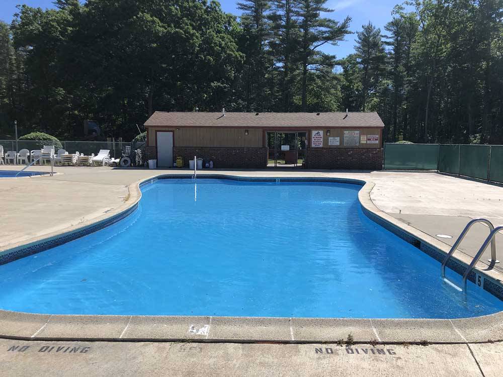 The swimming pool and clubhouse at NATURES CAMPSITES