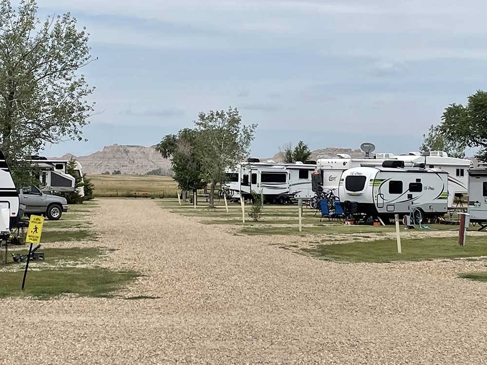 A gravel road leading to RV spots BADLANDS MOTEL & CAMPGROUND