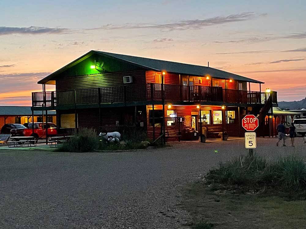 The office building lit up at night at BADLANDS HOTEL & CAMPGROUND
