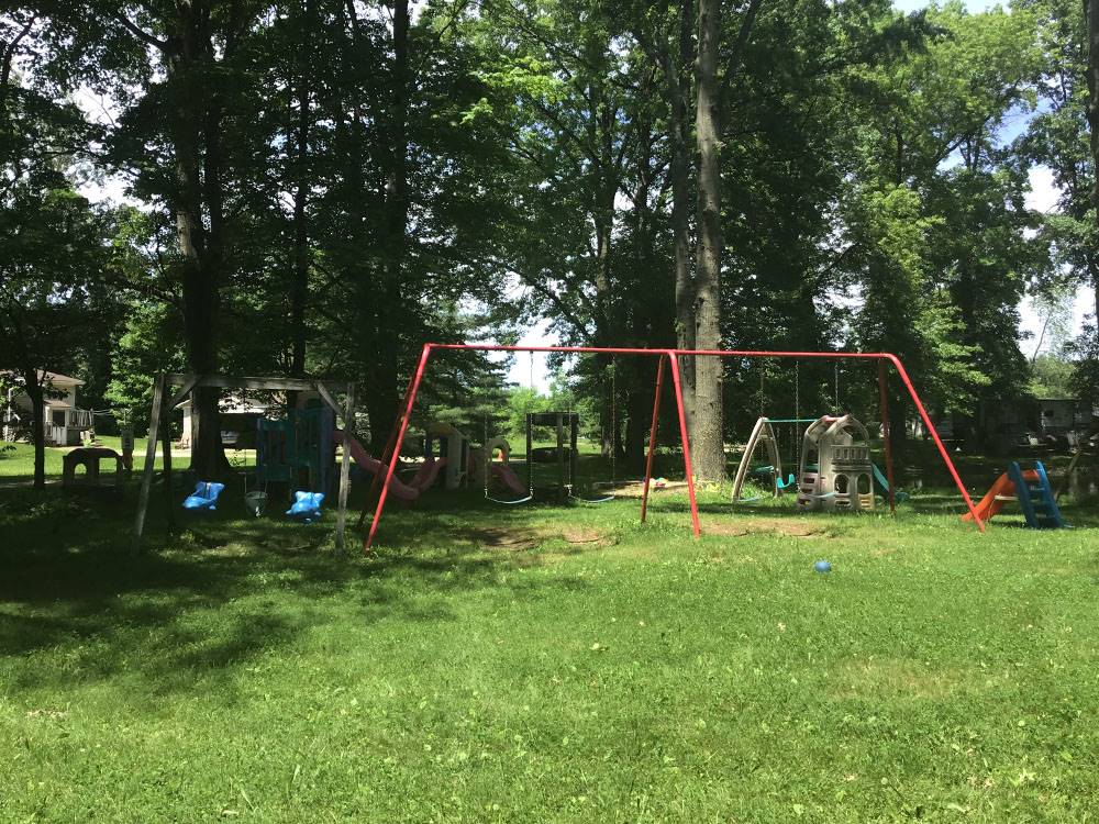 Red swingset in the grass at Cherokee Park Campground