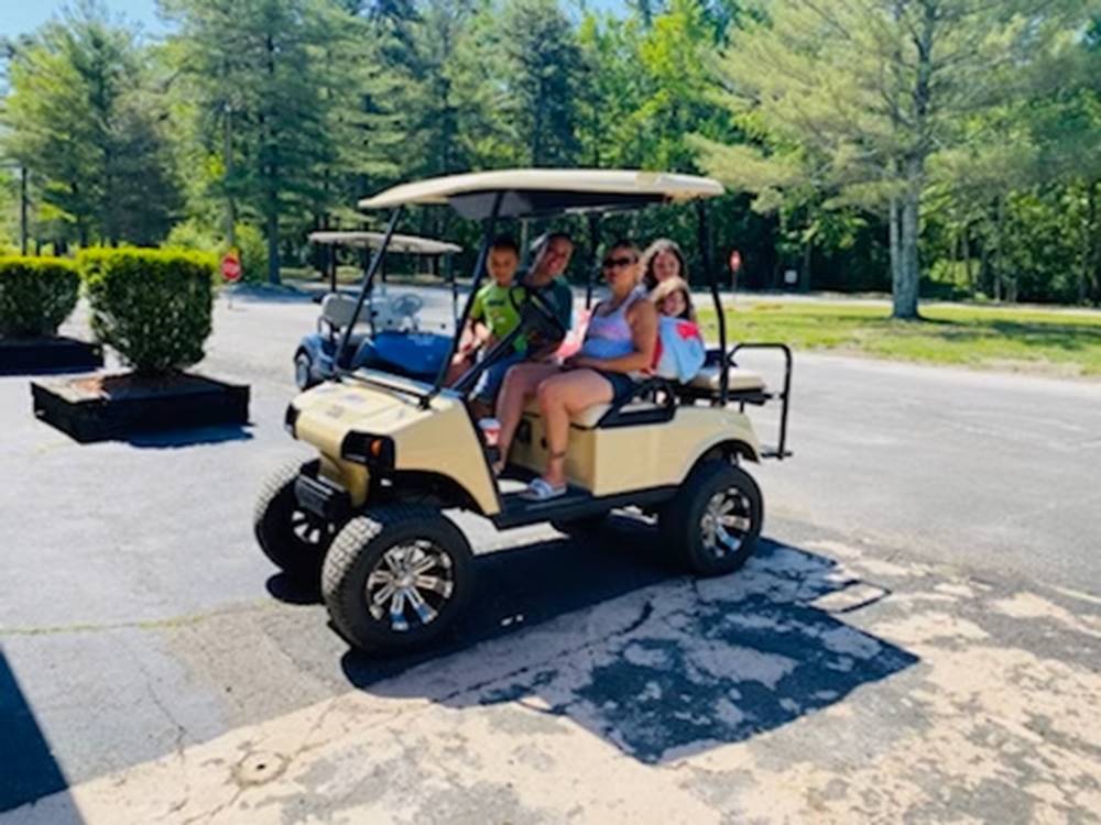 People sitting in a golf cart