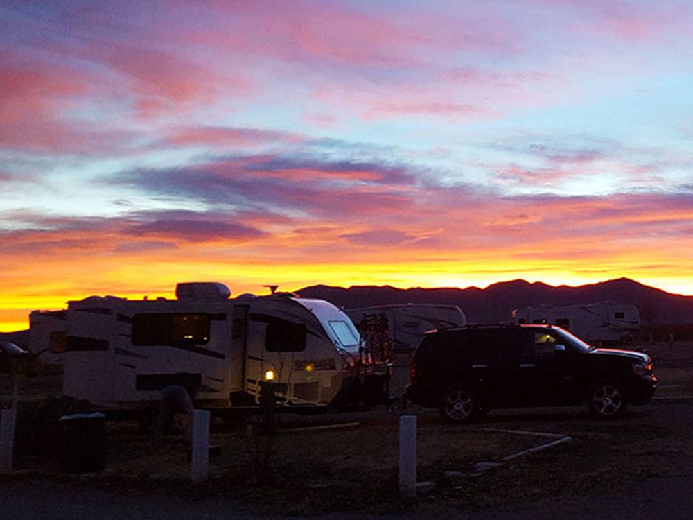 RVs parked in sites at sunset at VAN HORN RV PARK