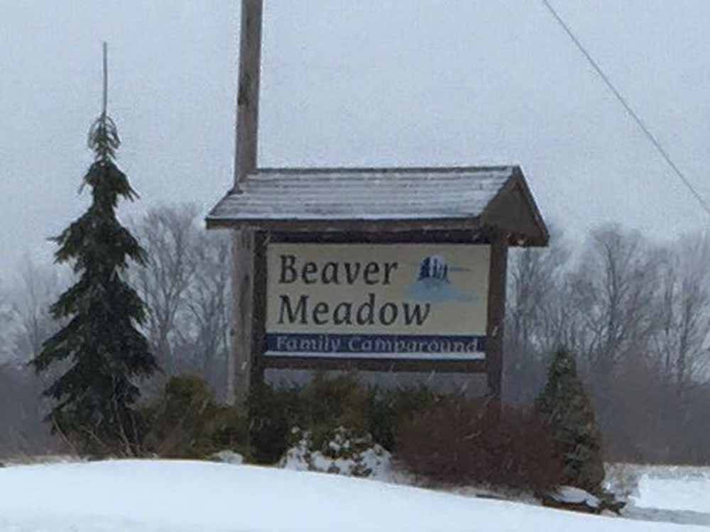 The front entrance sign in snow at BEAVER MEADOW FAMILY CAMPGROUND