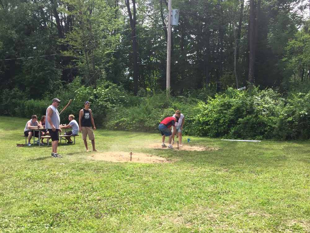 A group of people playing horseshoes at BEAVER MEADOW FAMILY CAMPGROUND