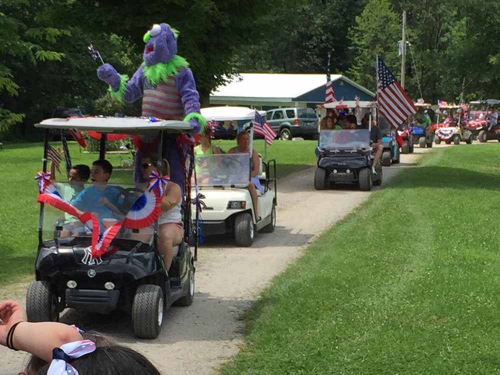 People doing a golf cart parade at BEAVER MEADOW FAMILY CAMPGROUND