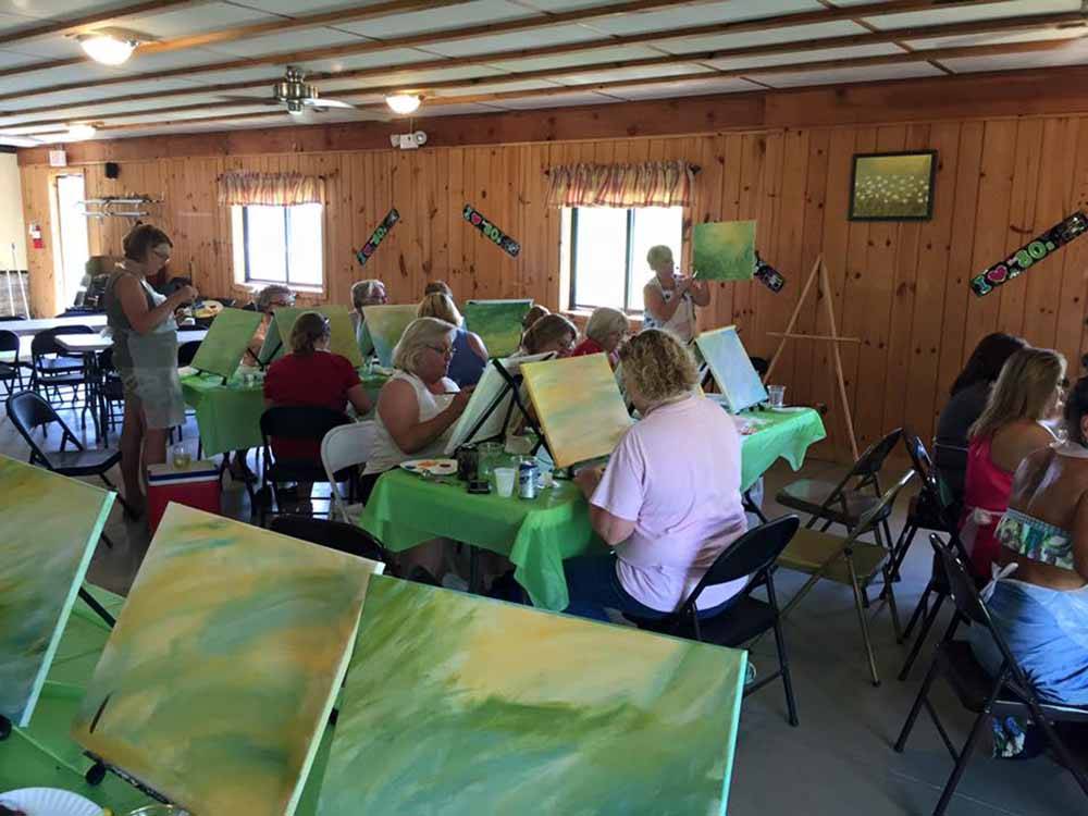 A group of people painting at BEAVER MEADOW FAMILY CAMPGROUND