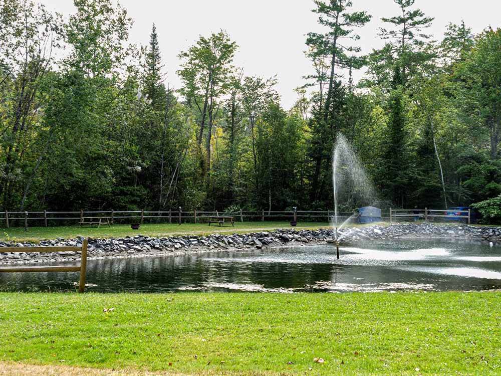 The fountain in the middle of the lake at REST N NEST CAMPGROUND