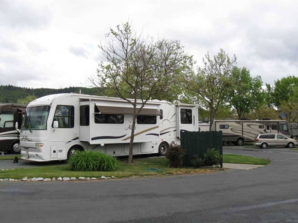 A motorhome in an RV site at ROGUE VALLEY OVERNITERS