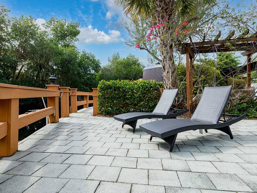 Lounge chairs in beautifully landscaped area at NORTHTIDE NAPLES RV RESORT