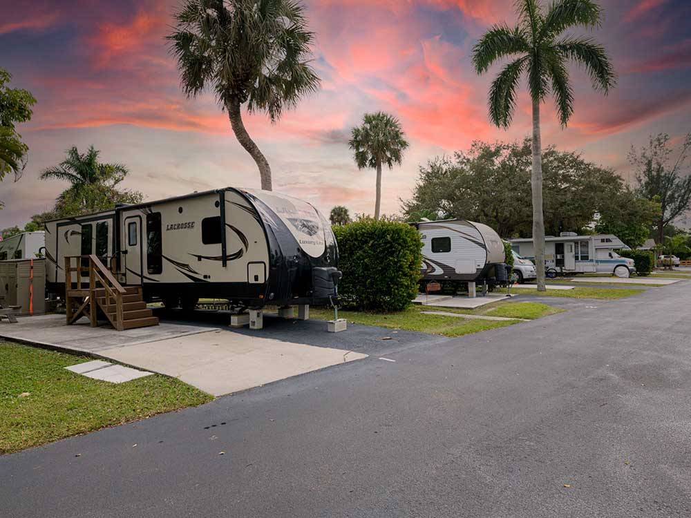 Trailers parked at campsites at sunset at NORTHTIDE NAPLES RV RESORT