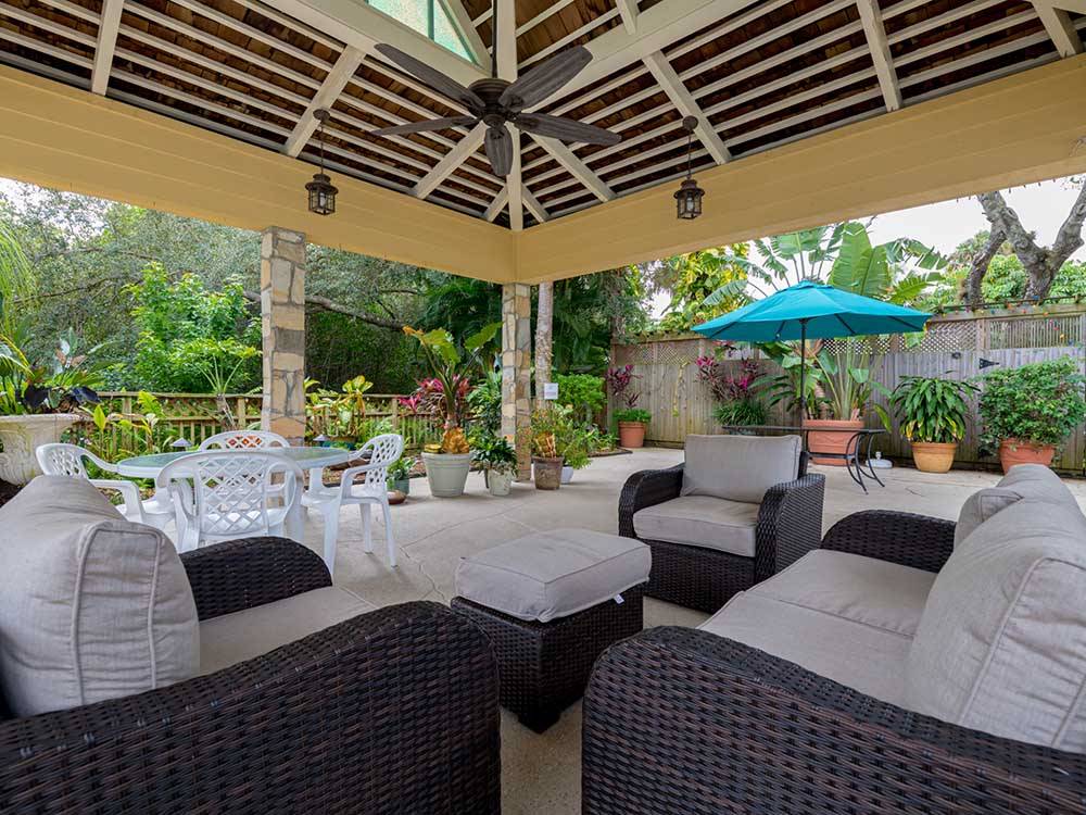 Covered lounge area with comfortable outdoor furniture at NORTHTIDE NAPLES RV RESORT