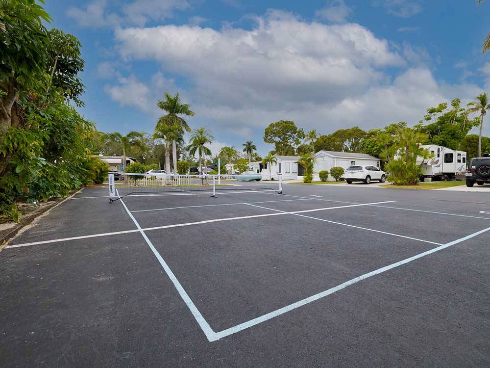 Tennis court next to the manufactured homes at NORTHTIDE NAPLES RV RESORT