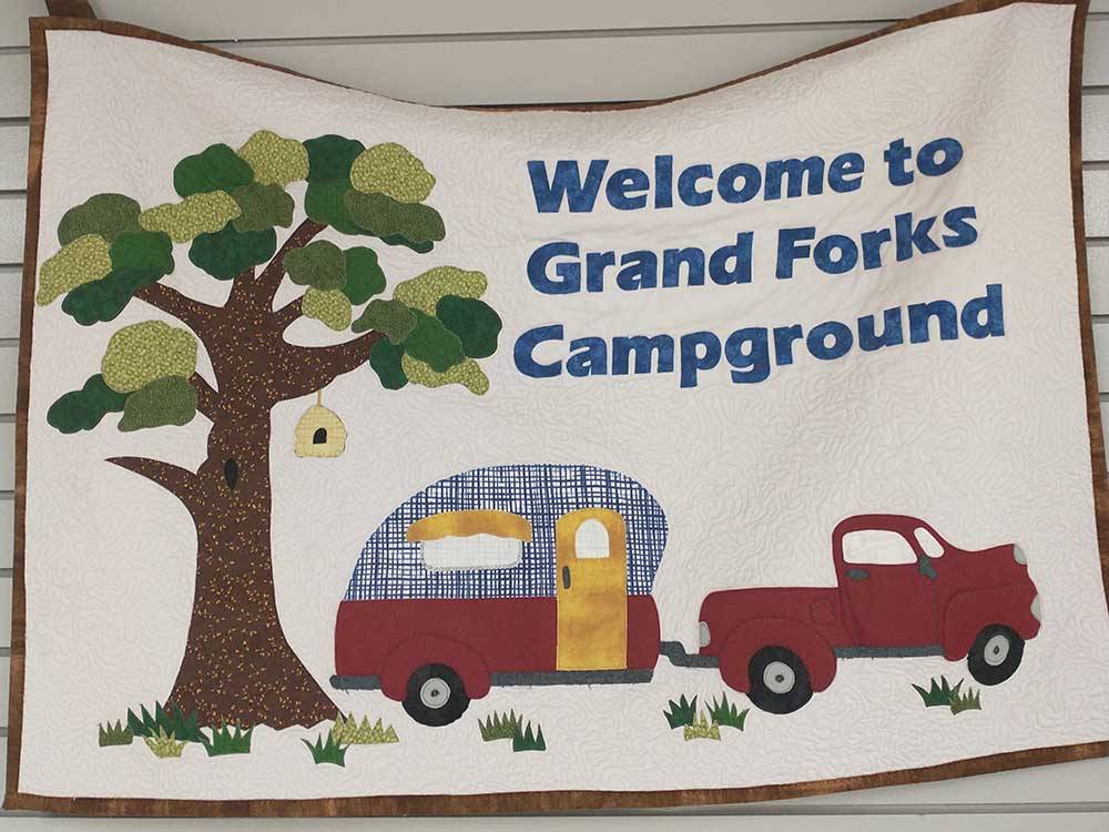 Welcome sign outside main building at GRAND FORKS CAMPGROUND